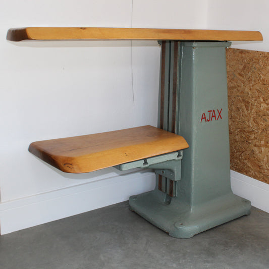 Reimagined industrial shelf handmade from a repurposed Ajax drill base with lacquered live edge oak surfaces.