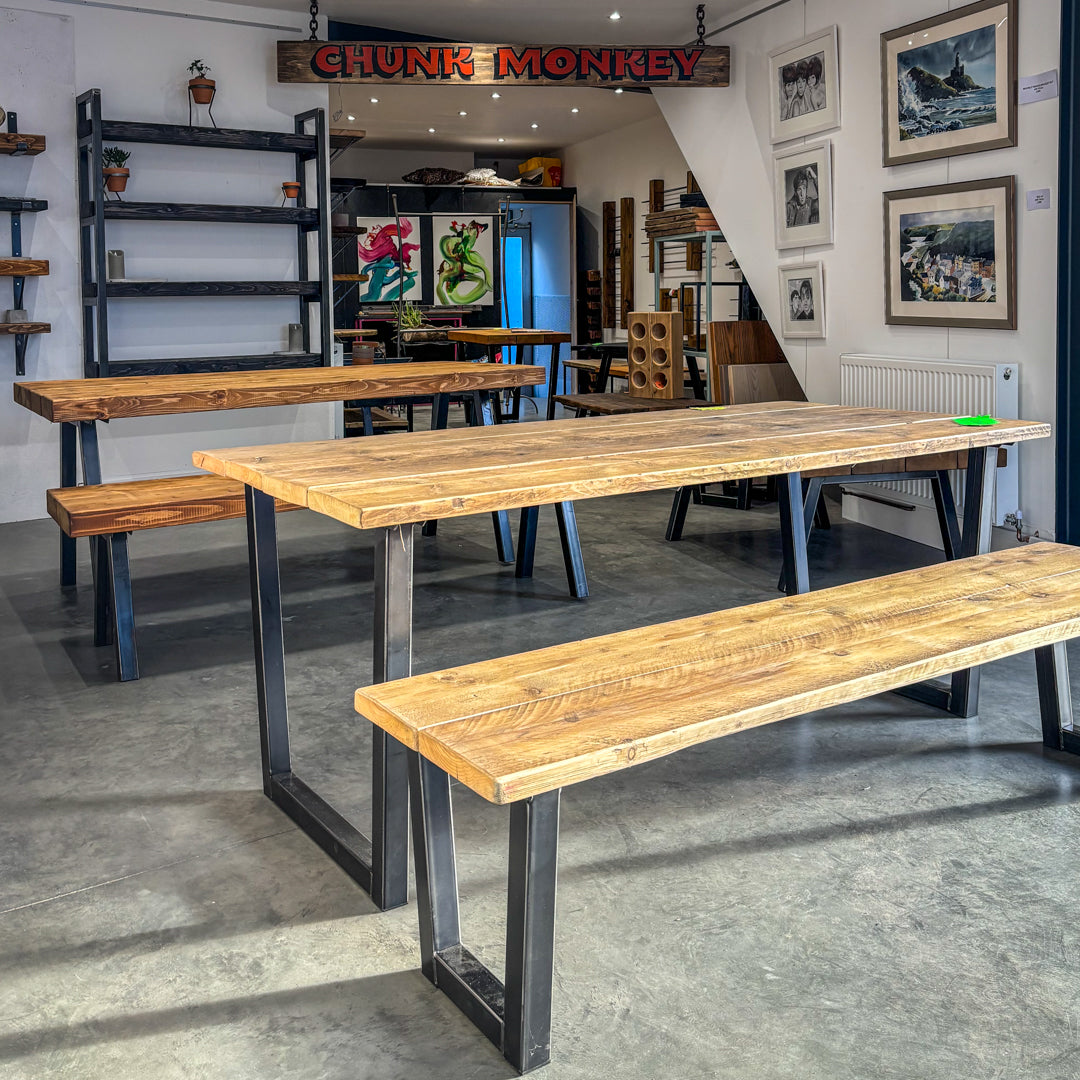 The BOX Furniture and Chunk Monkey showroom, showcasing a selection of dining tables and benches.