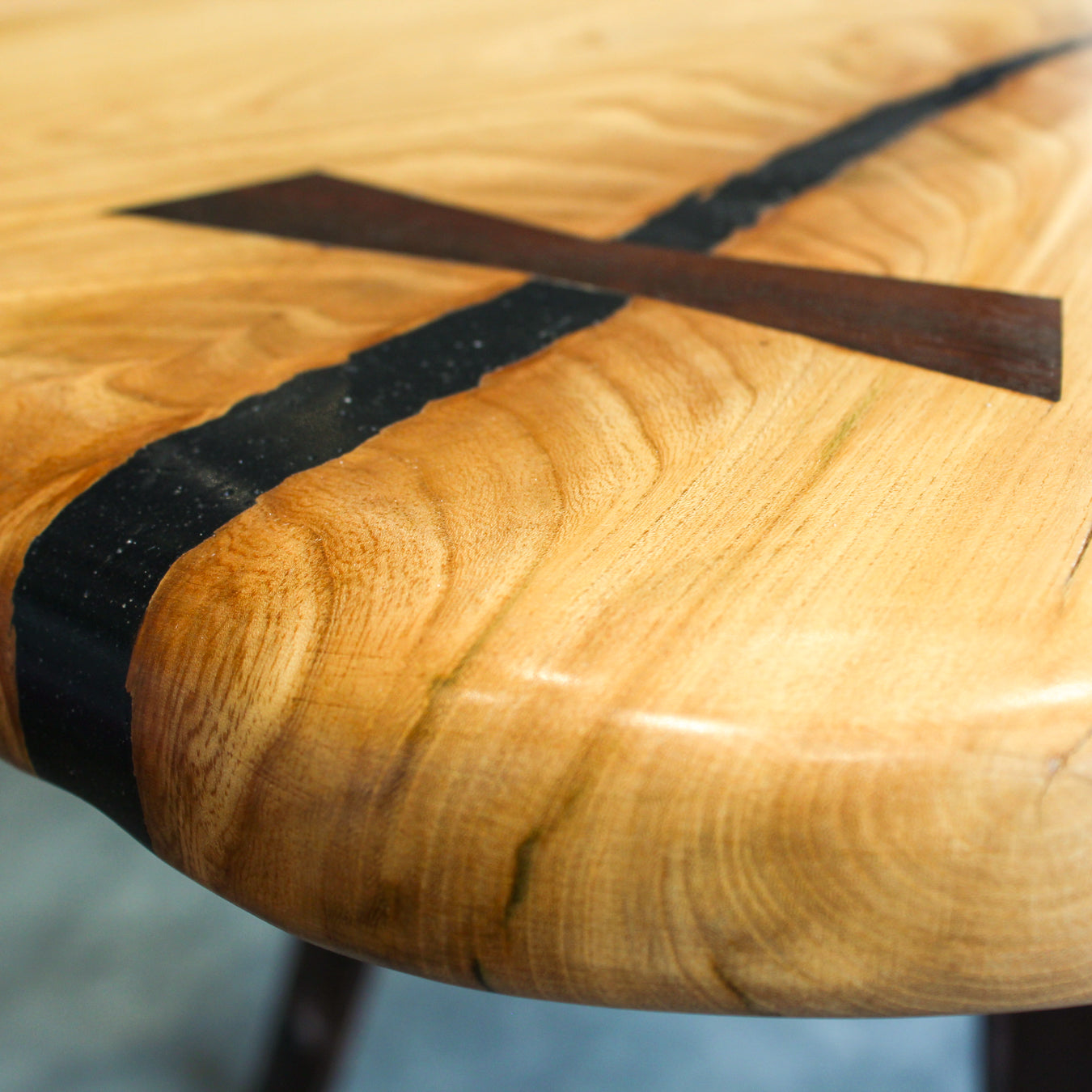 Detail of traditional bowtie inlays stabilising the elm top, highlighting craftsmanship.