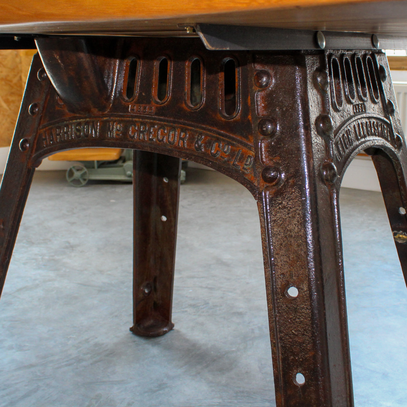 Close-up of the reclaimed cast iron legs with clear lacquer finish, showing aged texture and detail.