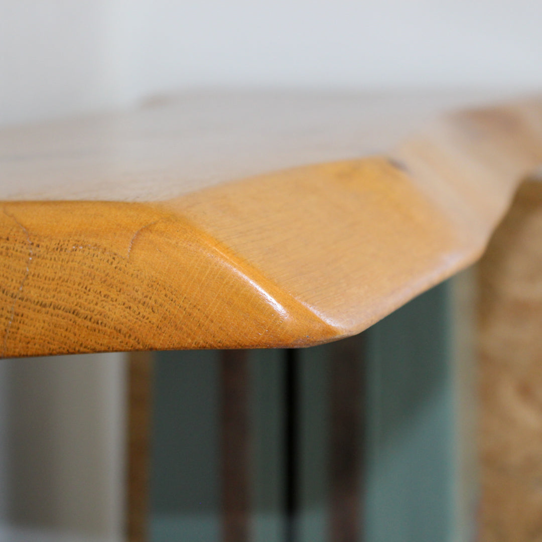 Close-up of the top live-edge oak shelf highlighting the smoothness and craftsmanship of the shelf.