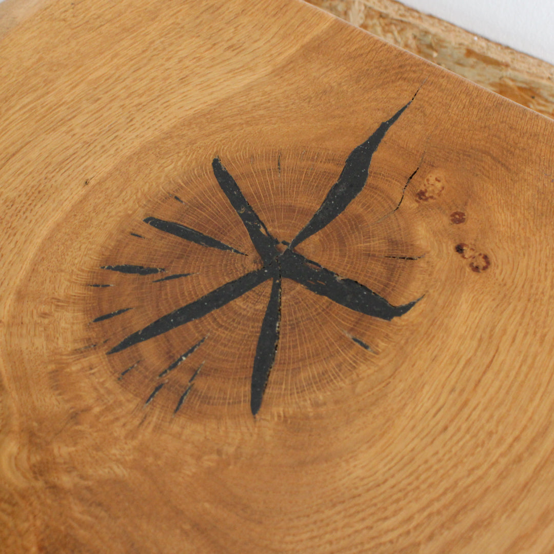 Close up of the oak showcasing a star-like pattern from the wood grain on the shelf top.