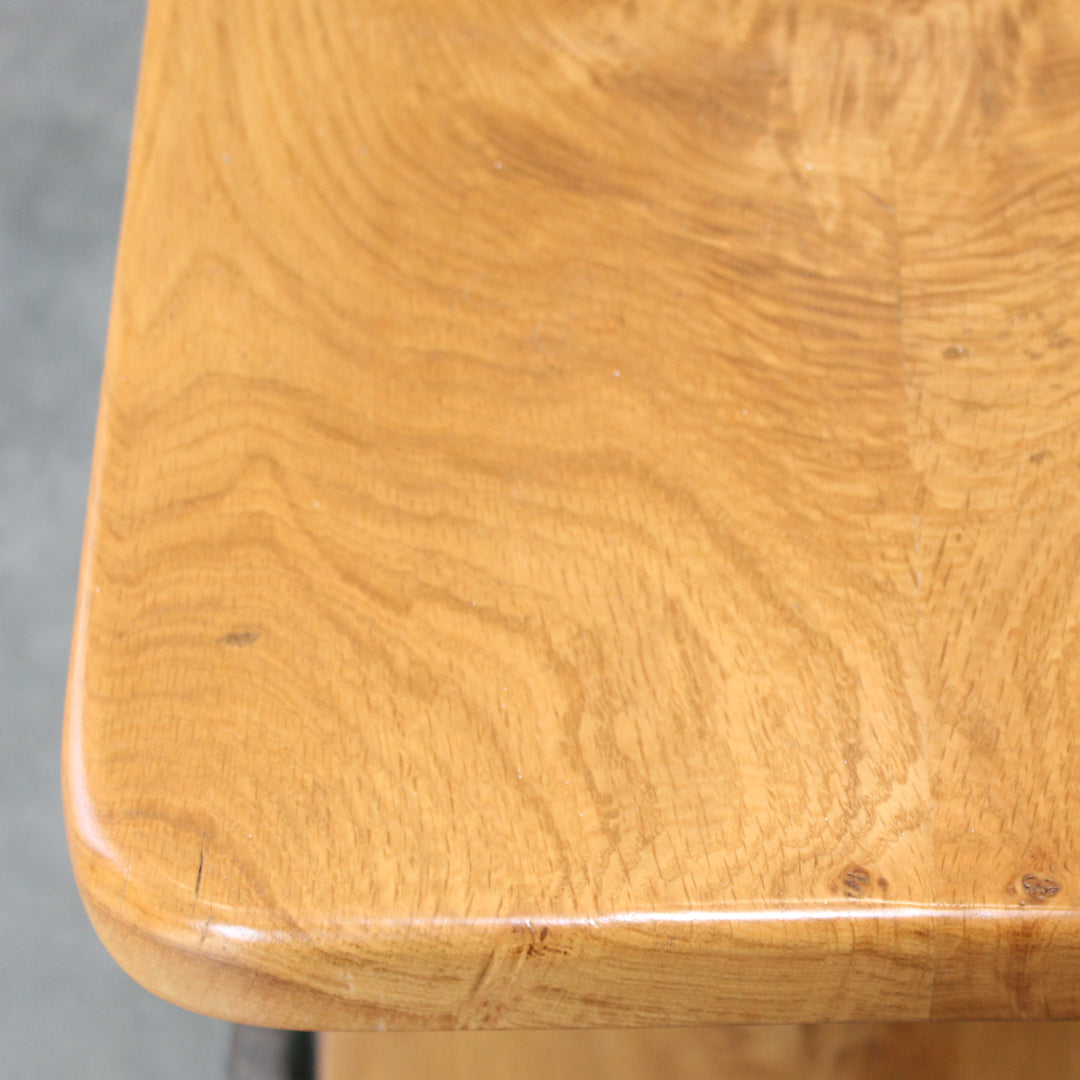 Close up of the top lacquered oak shelf on the repurposed weighing scales with a cast iron base.