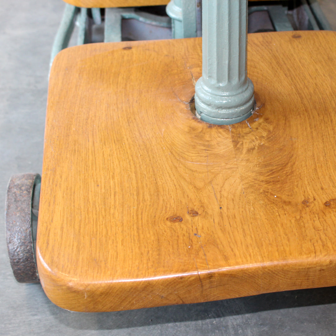 Close up of the bottom lacquered oak shelf on the repurposed weighing scales with a cast iron base.