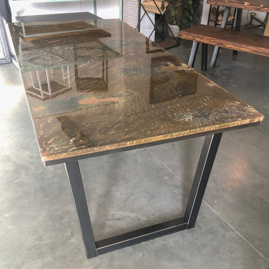 Handmade copper patina dining table with steel legs, showcasing a unique folded copper top and industrial design, crafted in Swansea.