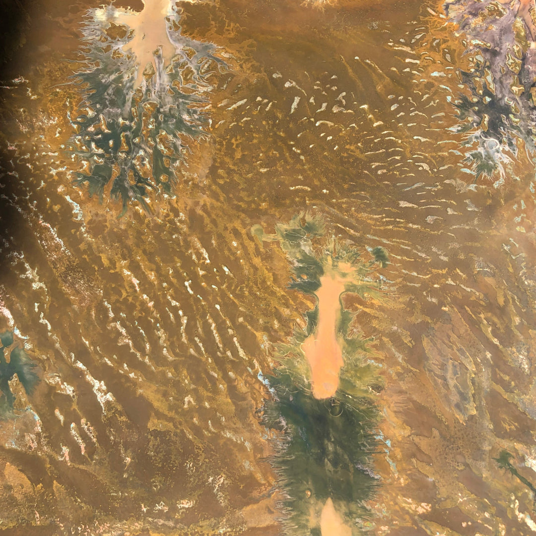 Close-up of a dark patina copper surface, featuring subtle patterns that will develop into green over time.